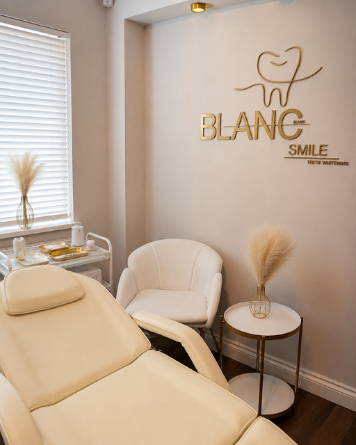 Blanc Smile shade guide held up in front of the gold studio logo